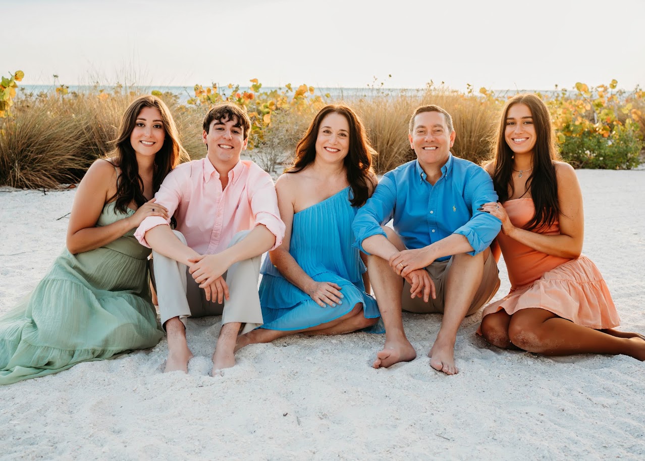 Laurie Albanos with her husband and three children on a Naples beach
